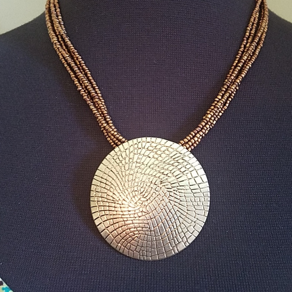Gold color necklace with metal medallion
